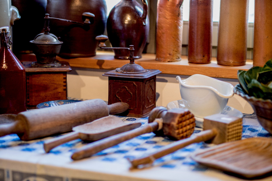 Old cooking tools on a wooden kitchen table. Accessories for coo