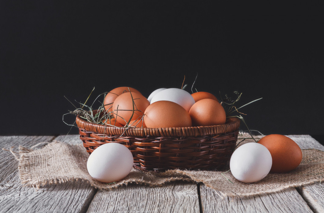 Fresh chicken white and brown eggs on sack closeup, organic farm