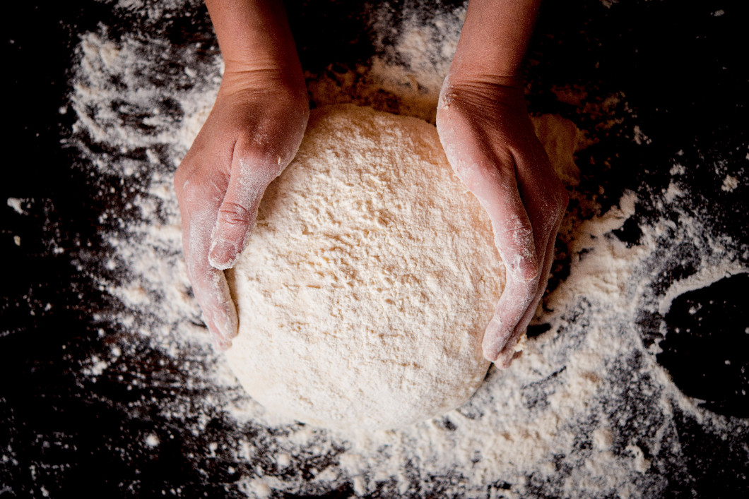 Hands holding a finished clean dough