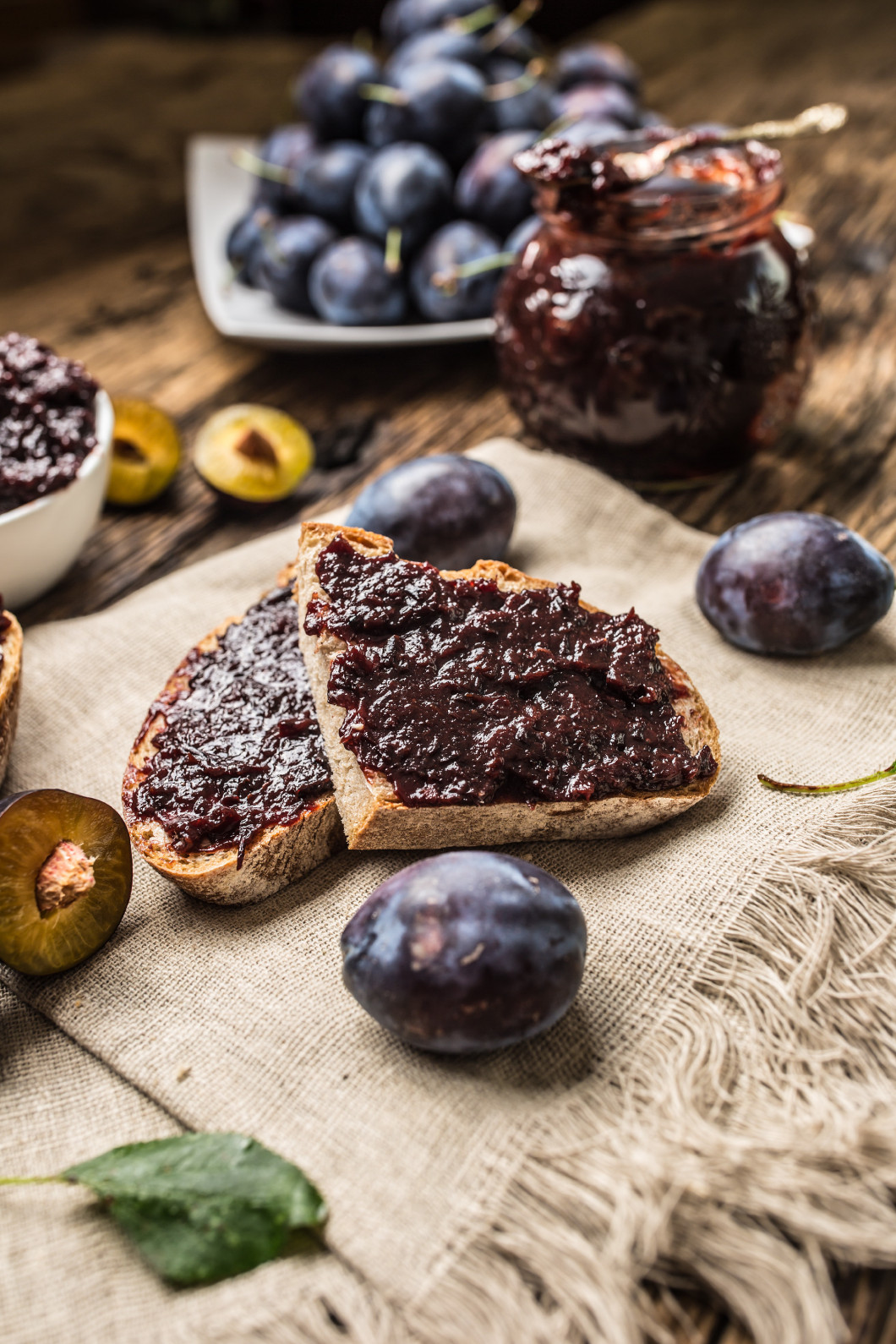 Breakfast from homemade plum jam bread and ripe plums.