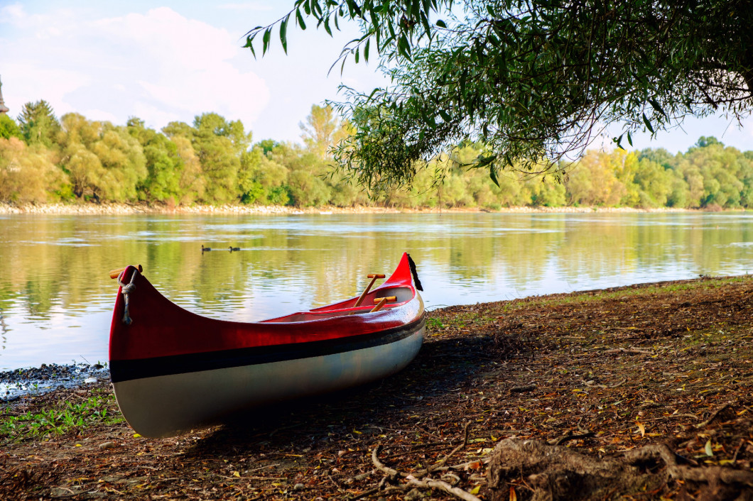 Red canoe on beach at river Danube