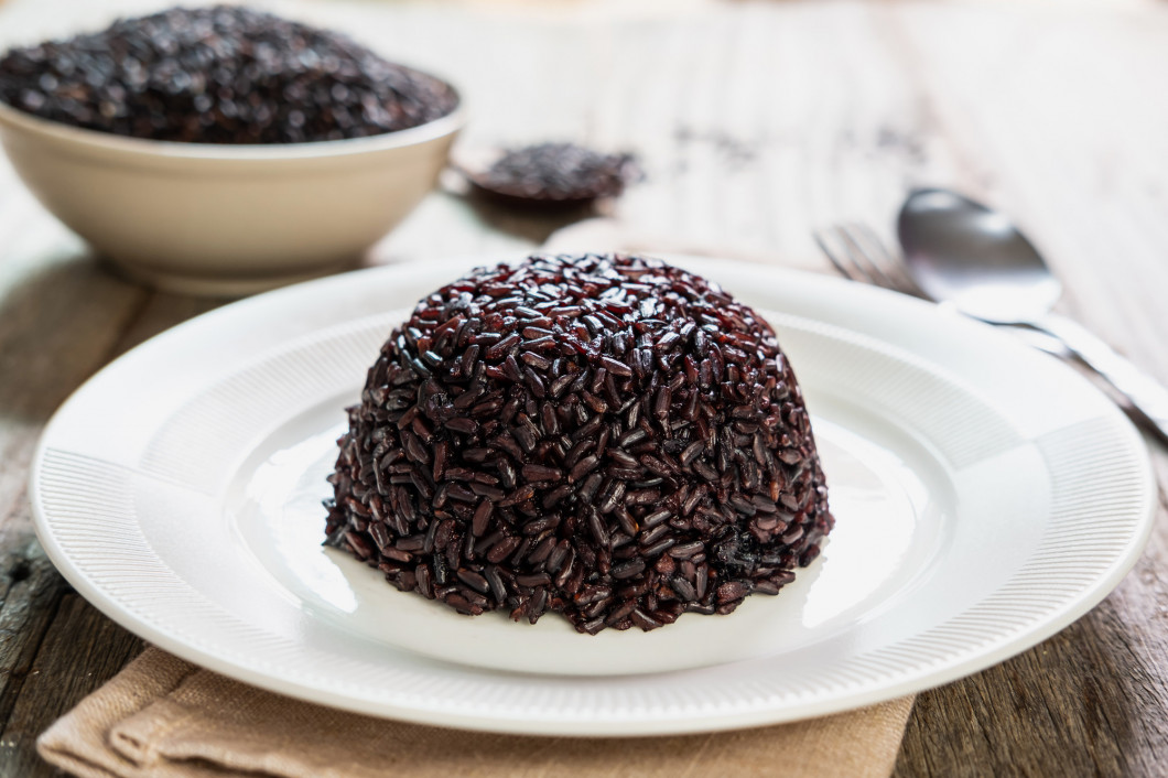 Close up of rice berry on white wooden table