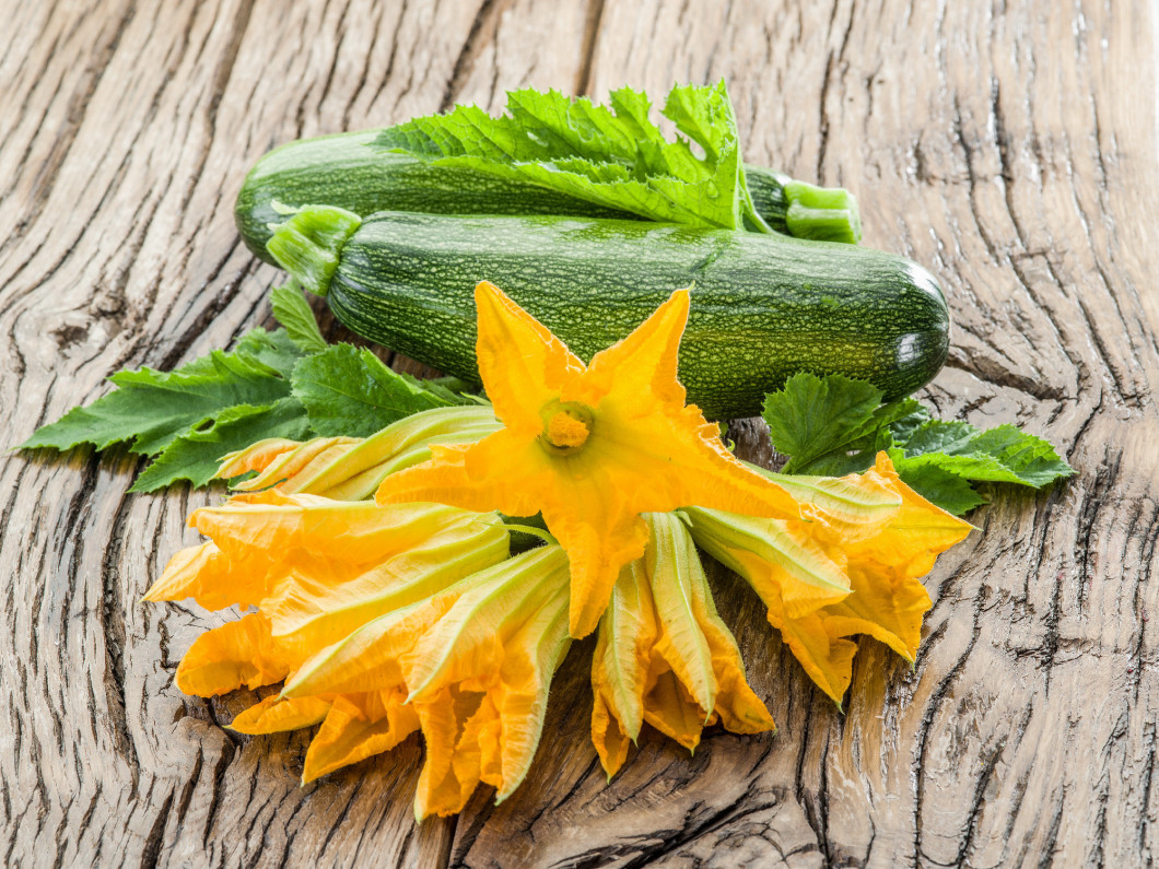 Zucchini flowers on a old wooden table.