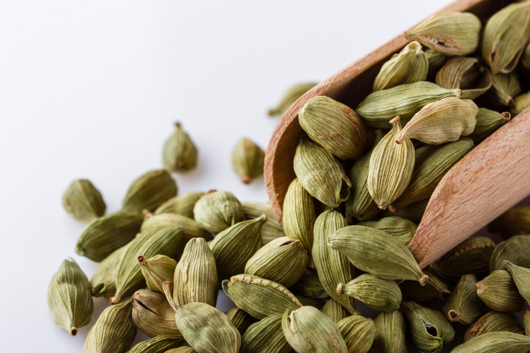 fragrant green cardamom on a white acrylic background