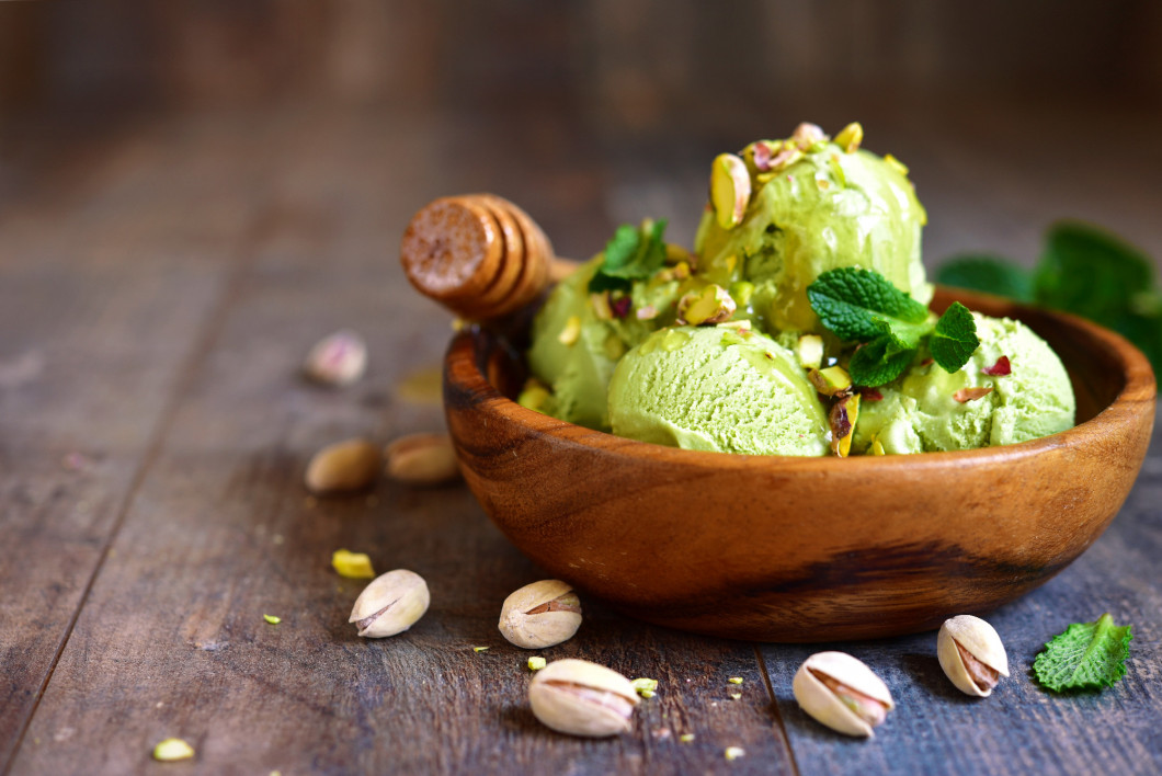 Pistachio ice cream with chopped nuts and honey.