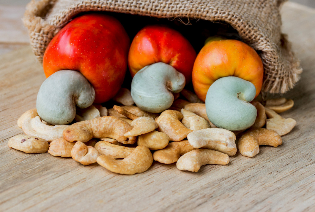 raw cashew nuts Fresh Cashew Nut pour from sack on wood