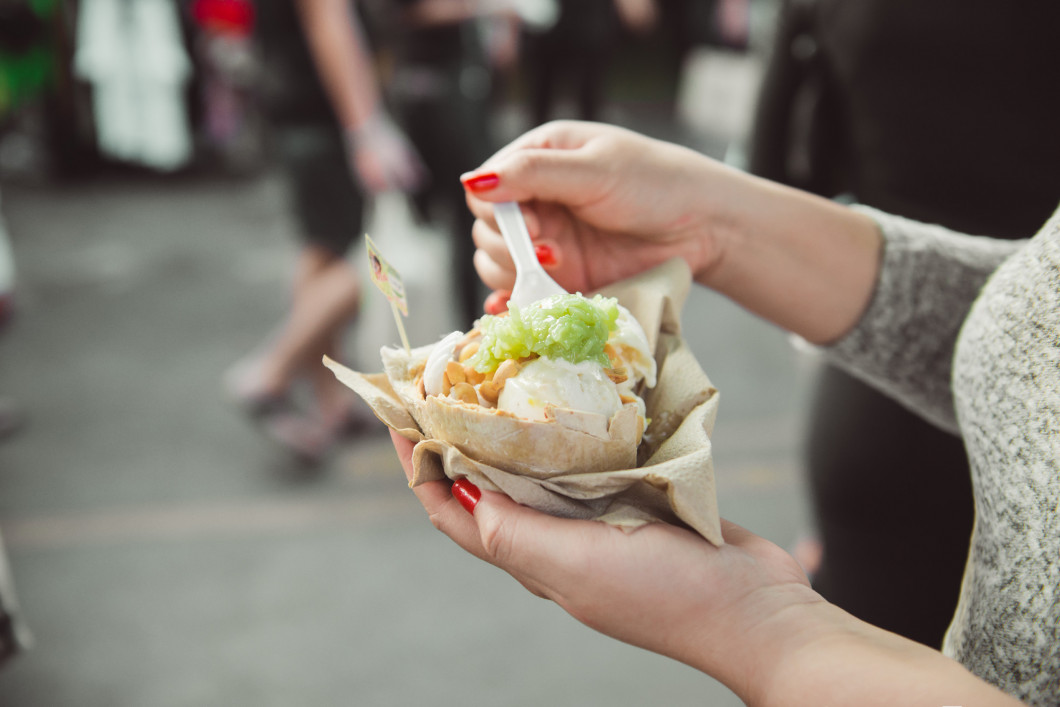 Woman hands holding ice cream on coconut