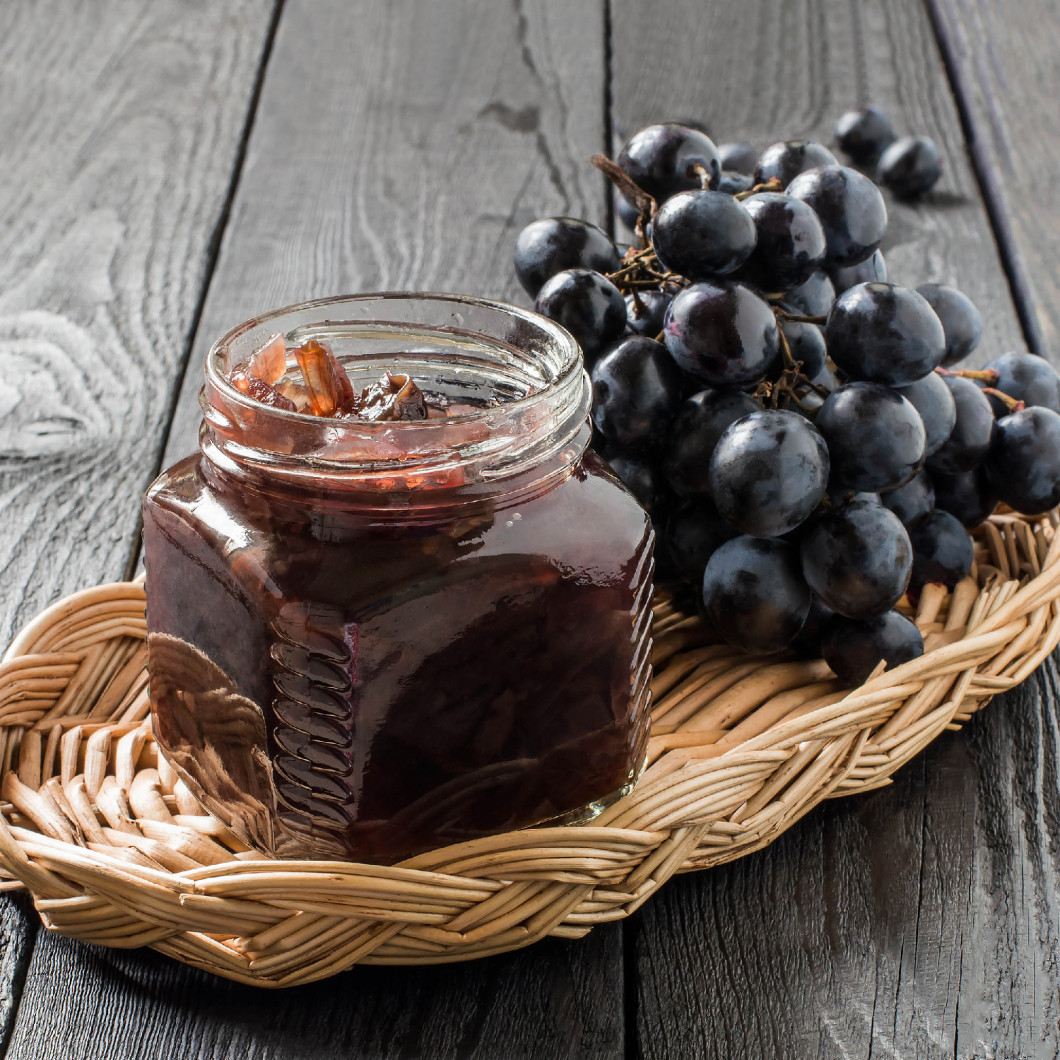 Onion jam with grapes in glass jars