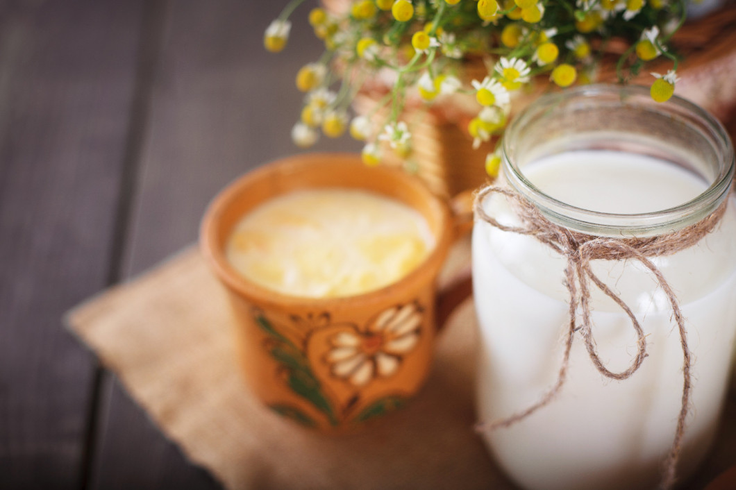 Fresh milk and curdled milk on the table.