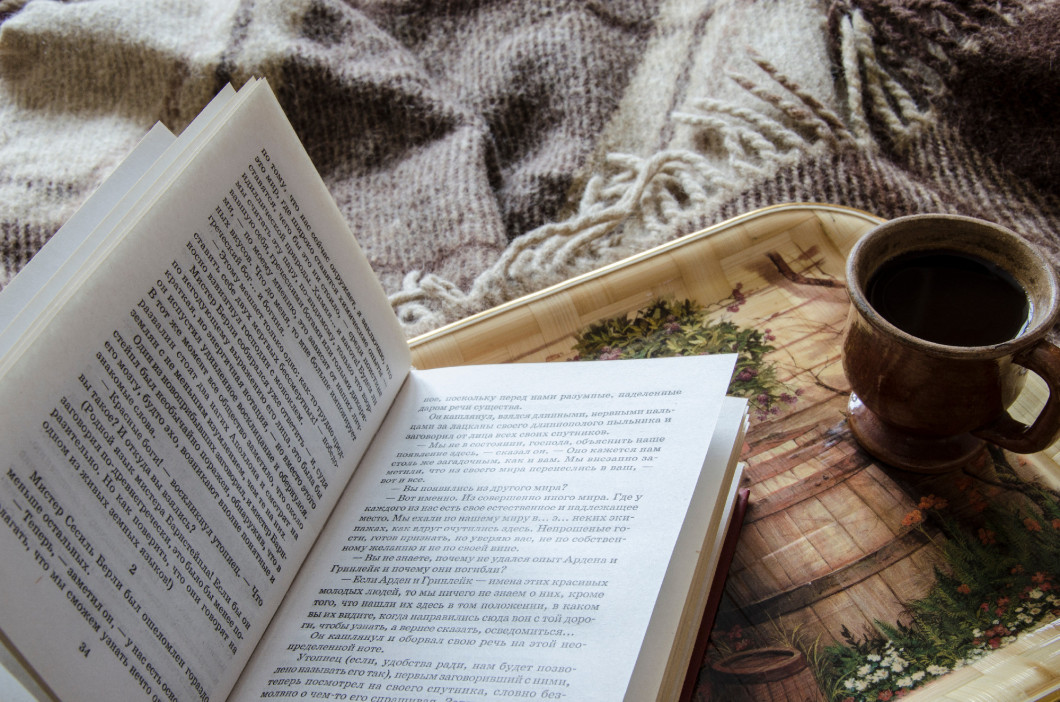 Cup of coffee and book on