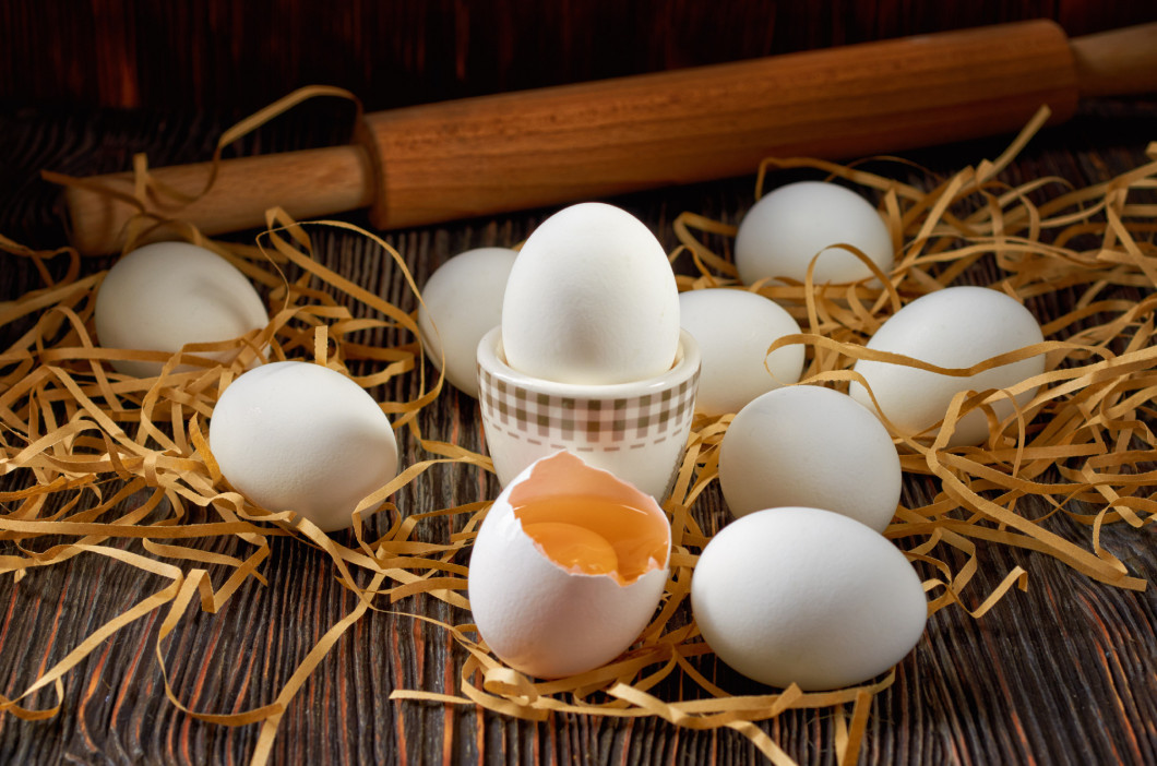 Fresh white eggs on the village table. Low key.