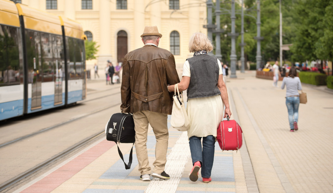Old couple travel in the city