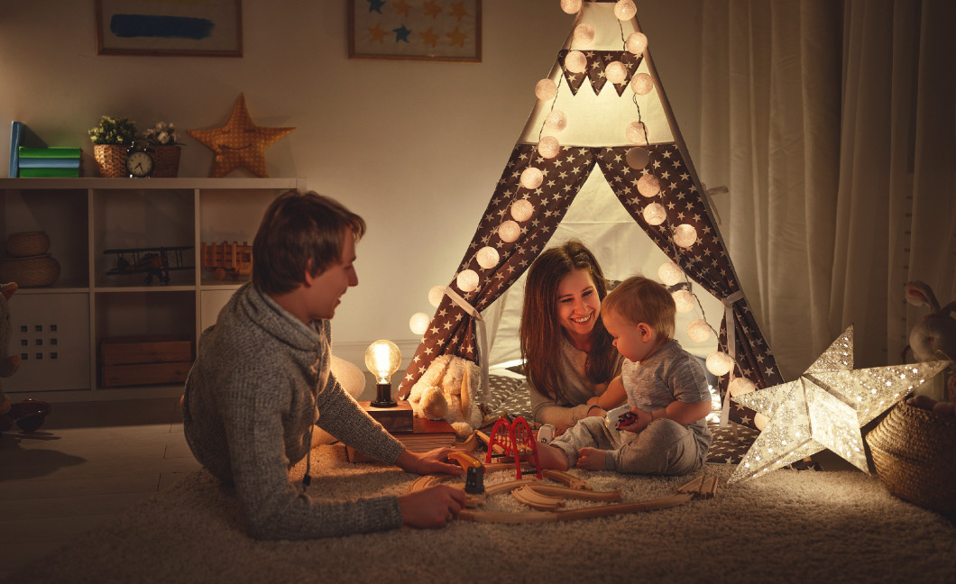family mother father and   son playing together in children's pl