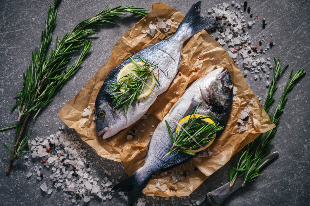 Top view of tasty dorado fish with vegetables and spices