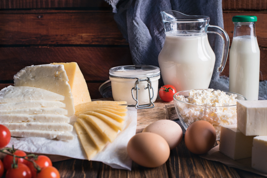 Farmers food products: milk, cream, cheese, eggs, cottage, butter. Rustic composition. Organic food concept