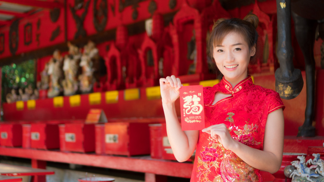 Asian girl in red dress.Chinese New Year.Cheongsam dress