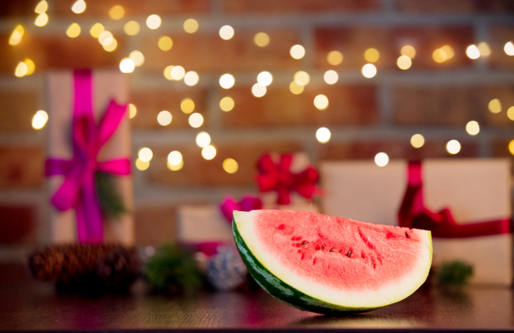 cut watermelon on background with fairy lights