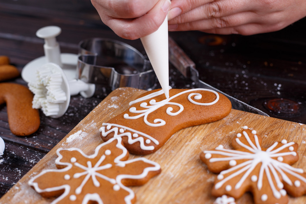 Decoration process of Christmas bakery.Woman hands with icing co