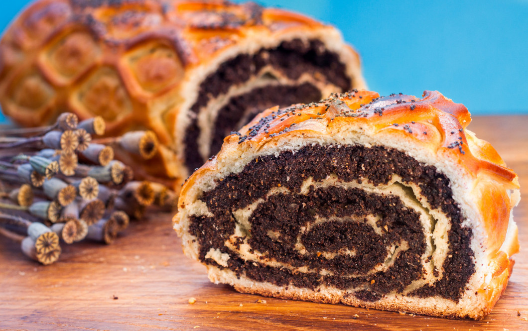 Poppy seed Roll on a wooden desk, closeup