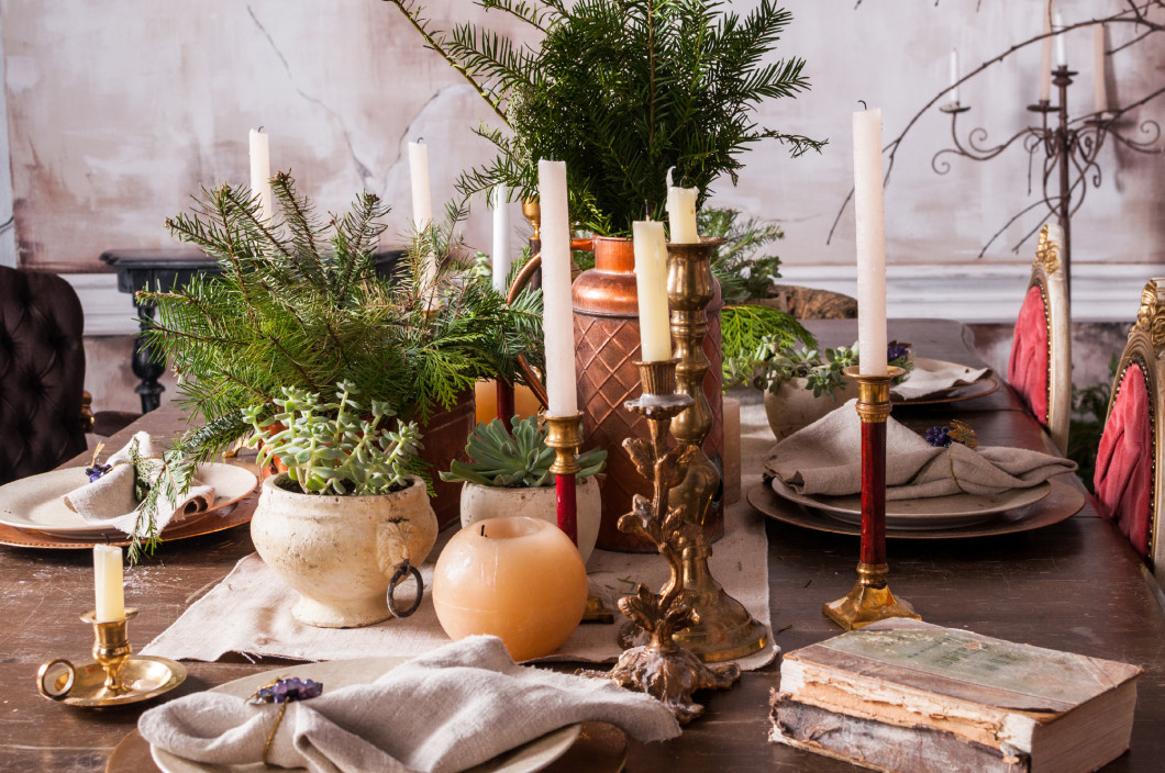 Dining table decorated for Christmas and evergreen centerpiece