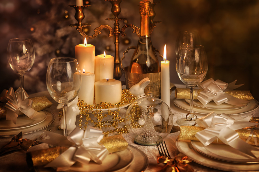 Festive dining table with lighted candles 