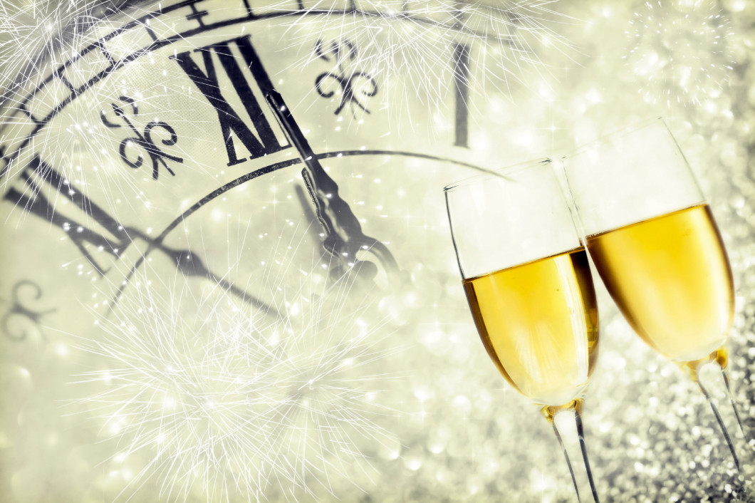 Glasses with champagne and clock close to midnight