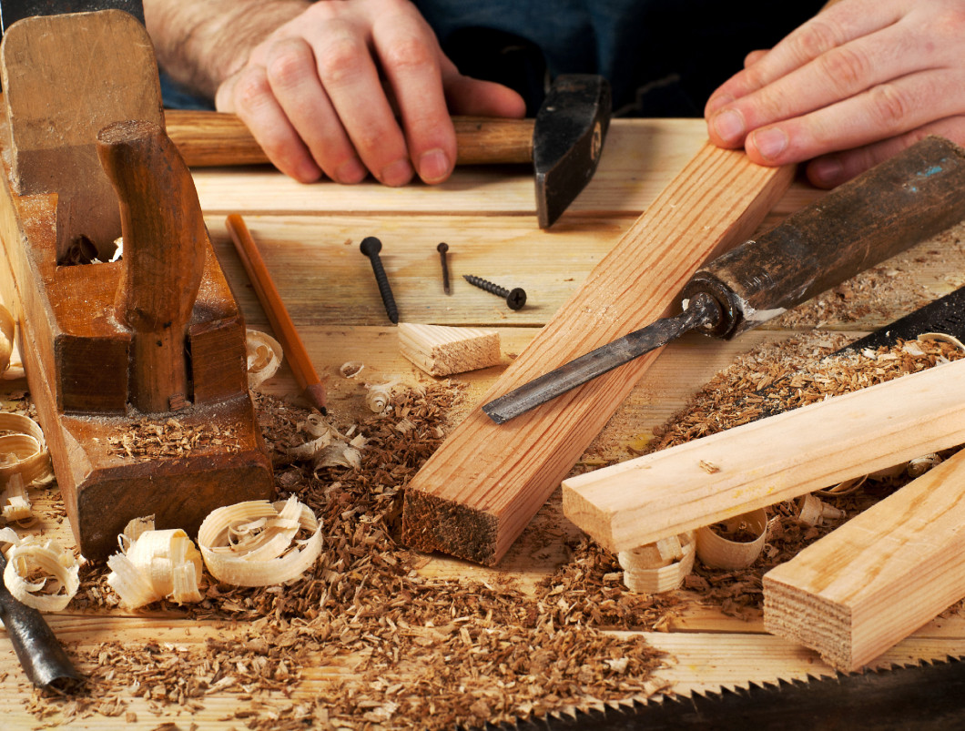 Carpenter tools on wood table background. Copy space. Top view