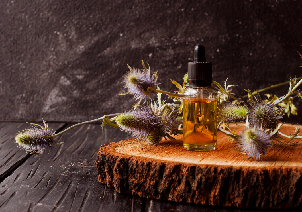 jar of burdock oil, spa, selective focus, space for text