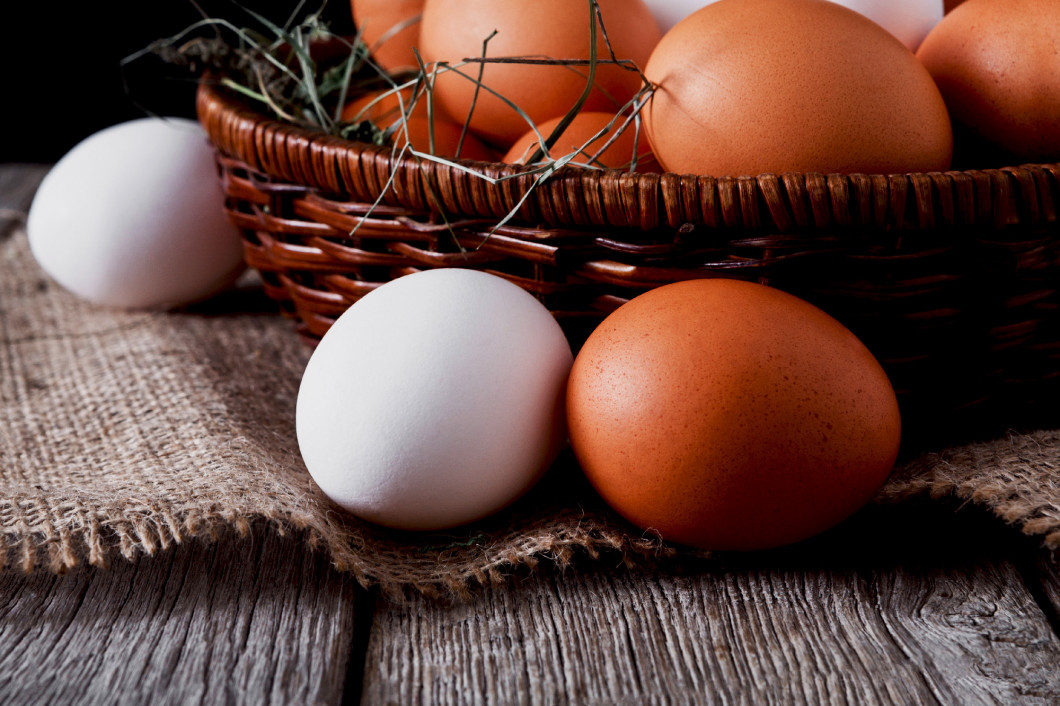 Fresh chicken white and brown eggs on sack closeup, organic farm