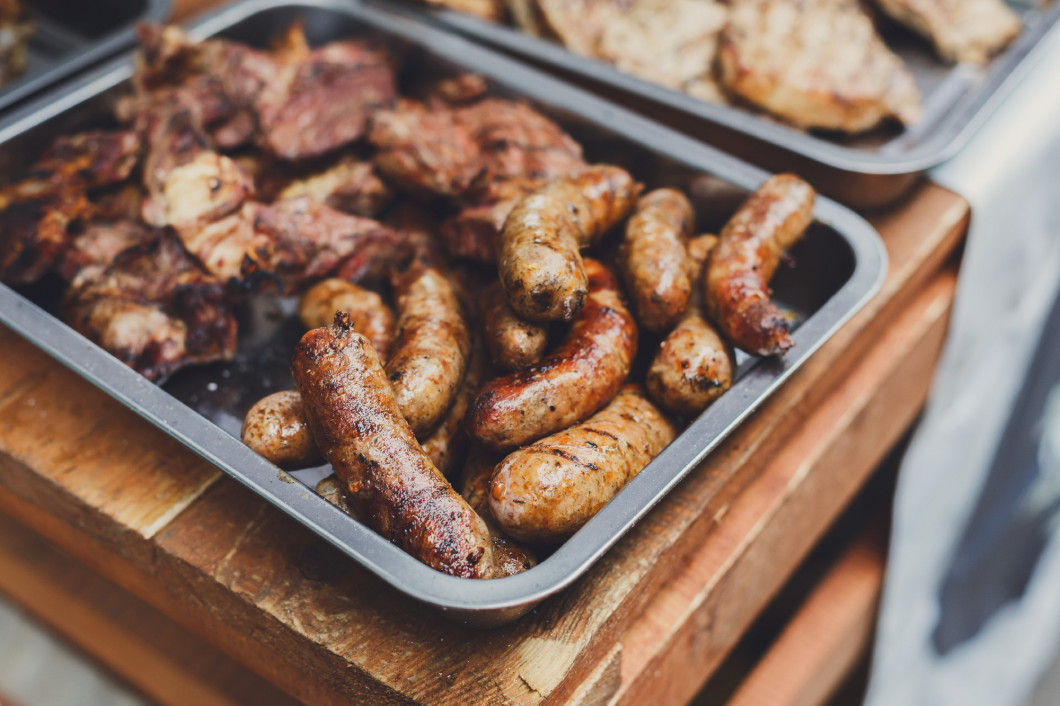 Street fast food, grilled sausages in container