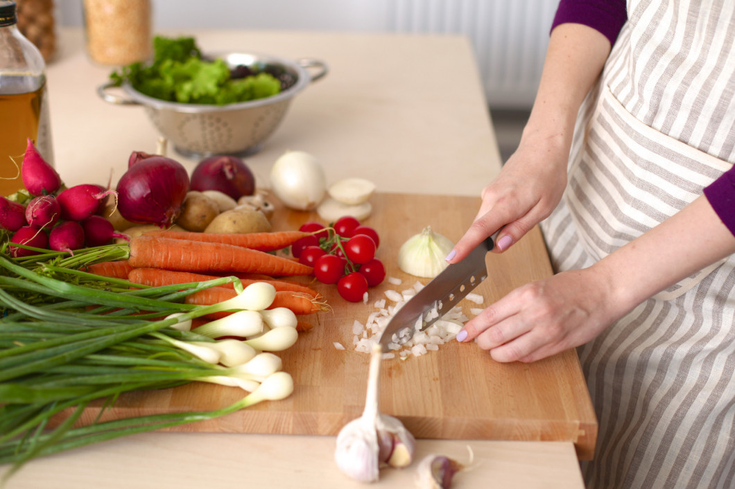 Young Woman Cooking in the kitchen. Healthy Food