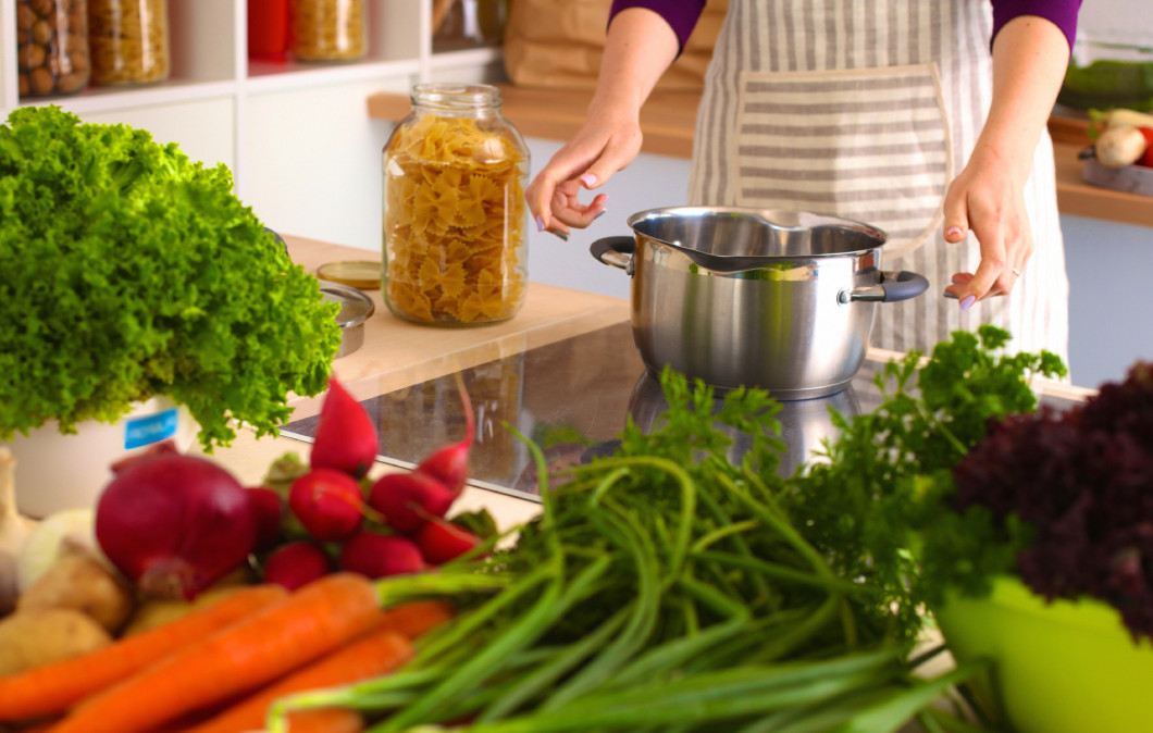 Young Woman Cooking in the kitchen. Healthy Food