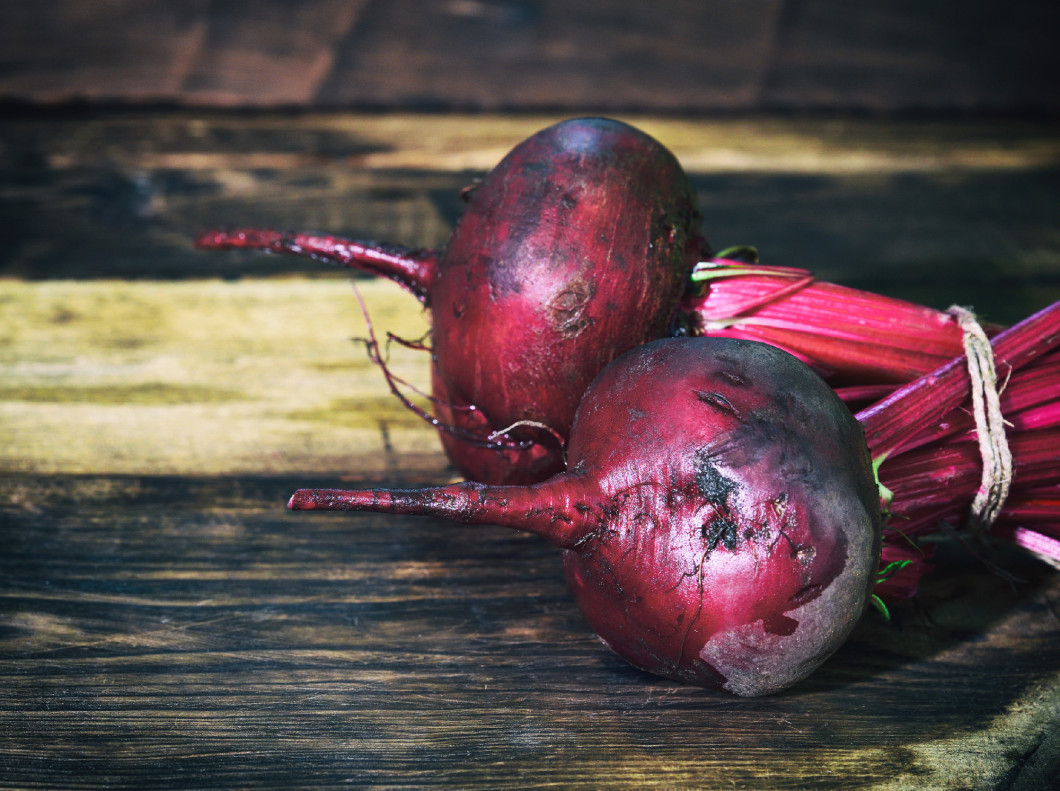 fresh red beet on a brown table