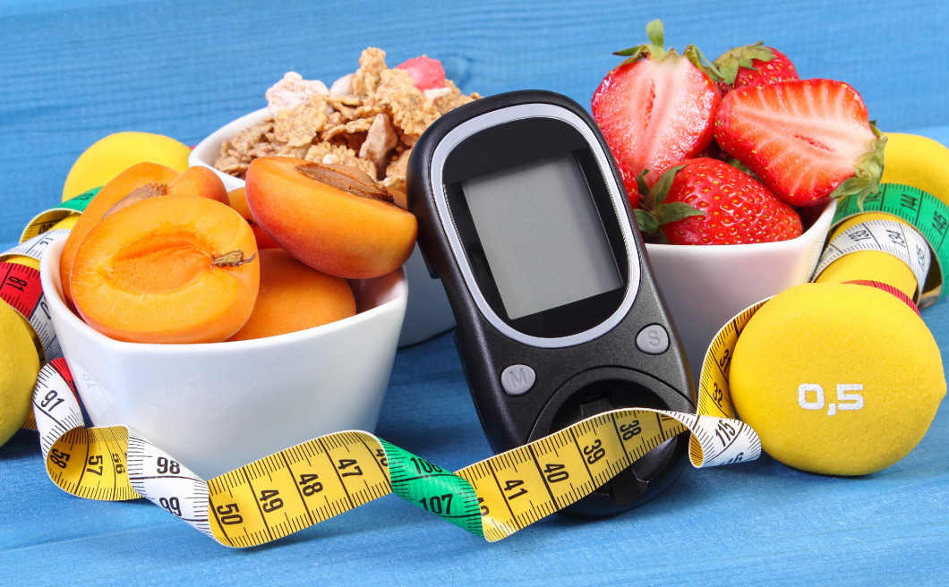 Glucometer, healthy food, dumbbells and centimeter, diabetes, healthy and sporty lifestyle concept