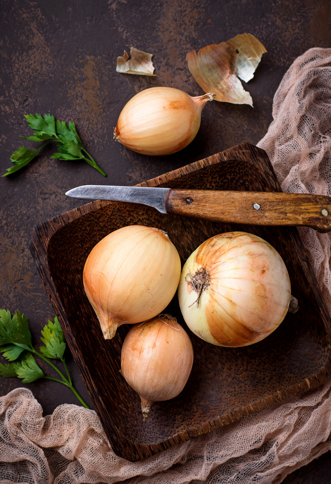 Raw onions on rusty background