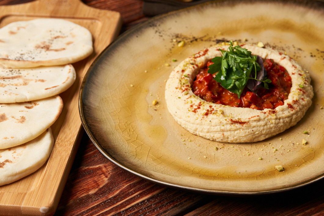 Hummus with harissa sauce and pistachios