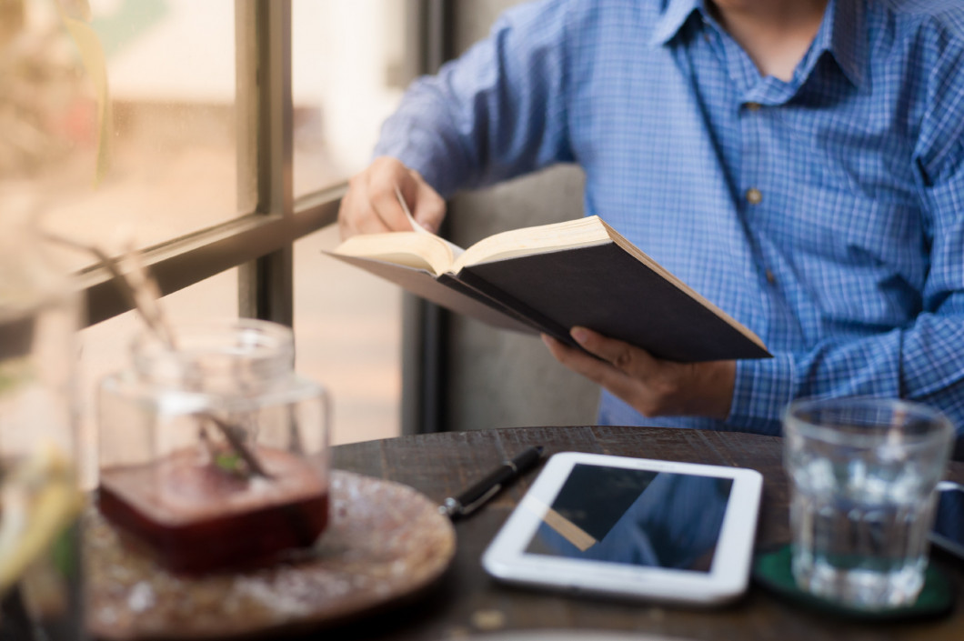 Man reading book in cafe