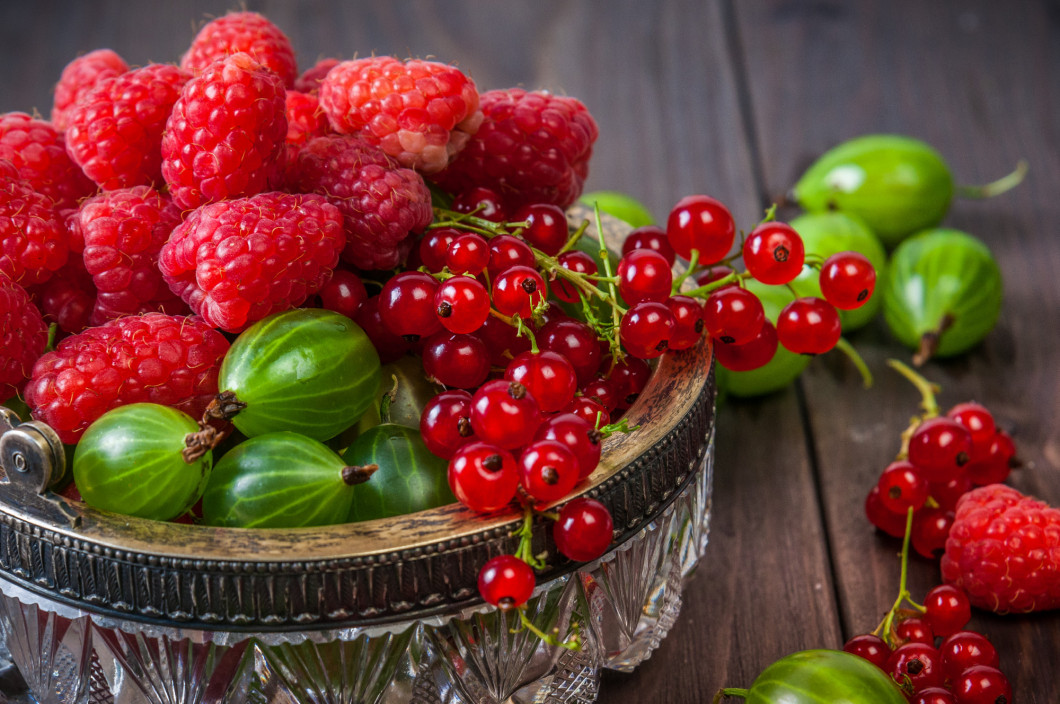 Mix of fresh organic berries isolated on vintage wooden table background