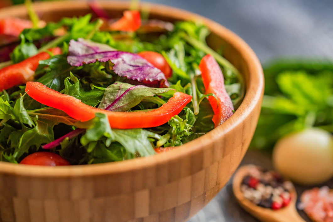 Fresh rustic vegetable salad on rustic background