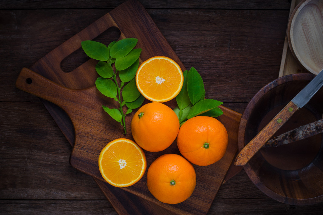 Fresh organic oranges fruits on wooden background.