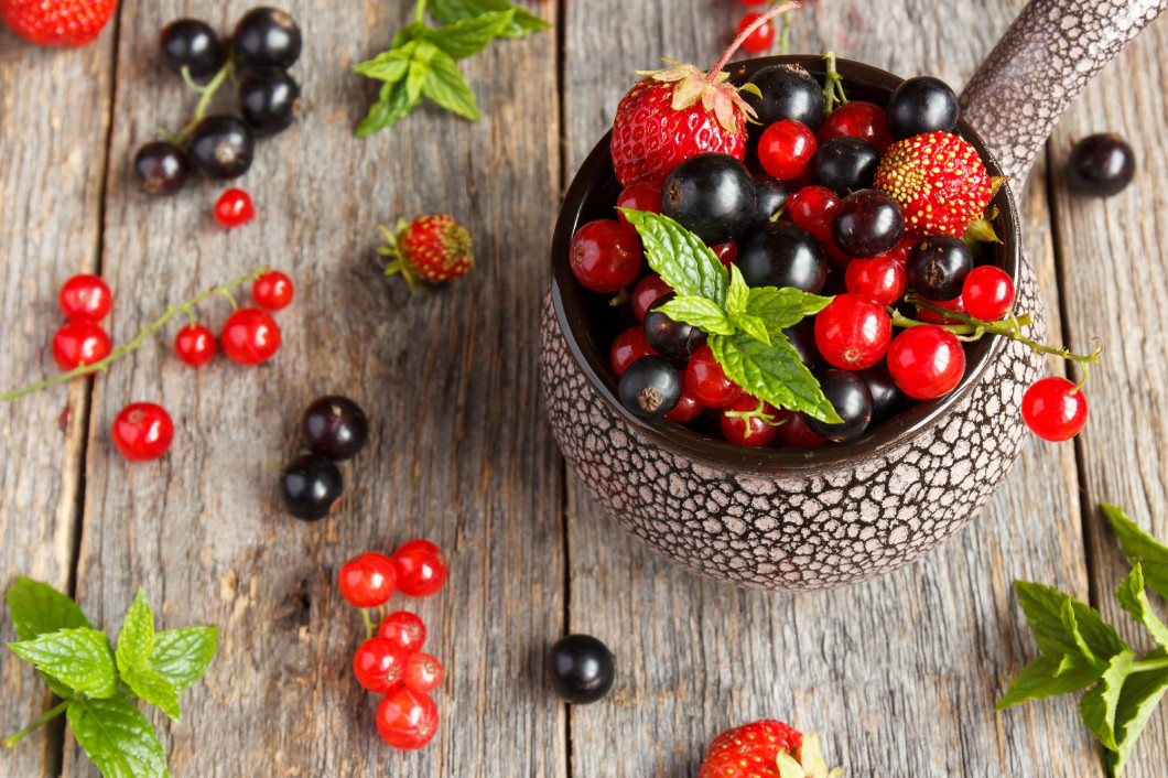 Fresh berries. Various summer berries in a bowl on rustic wooden table.