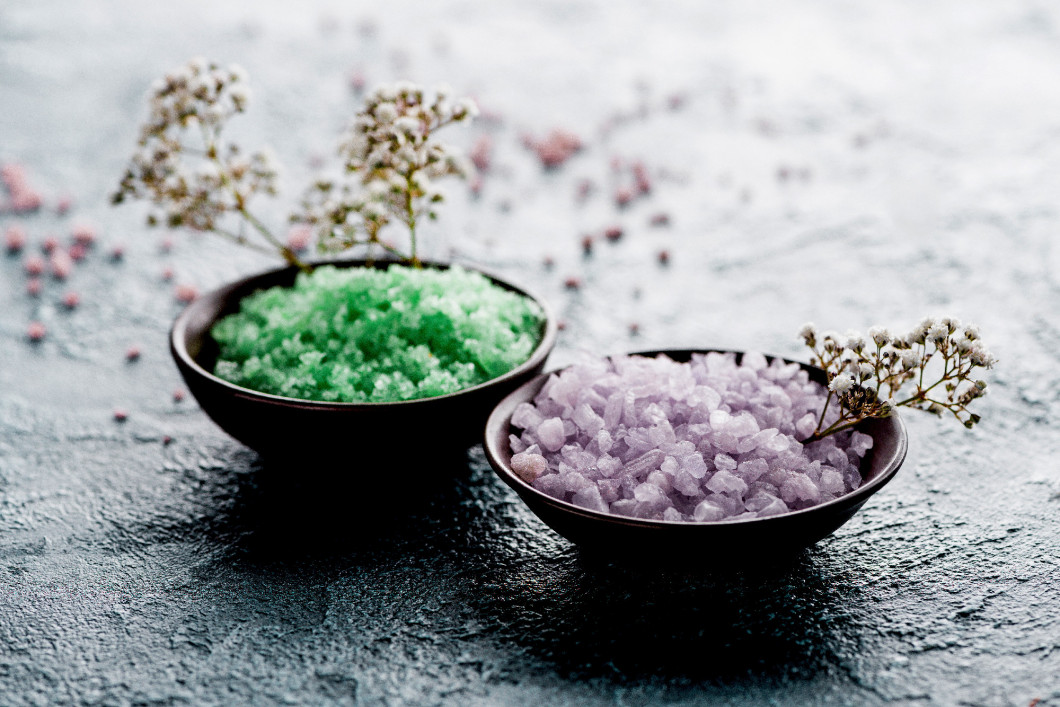 close-up view of sea salt in bowls and small white flowers