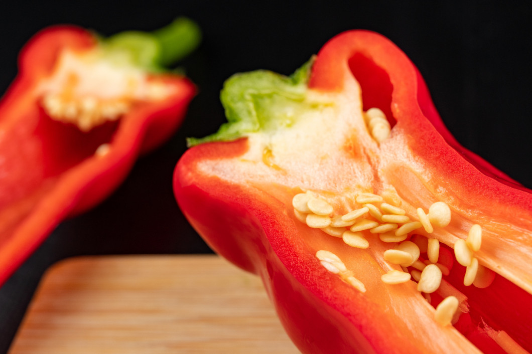 Ripe red paprika on a wooden board. Healthy vegetables in a home