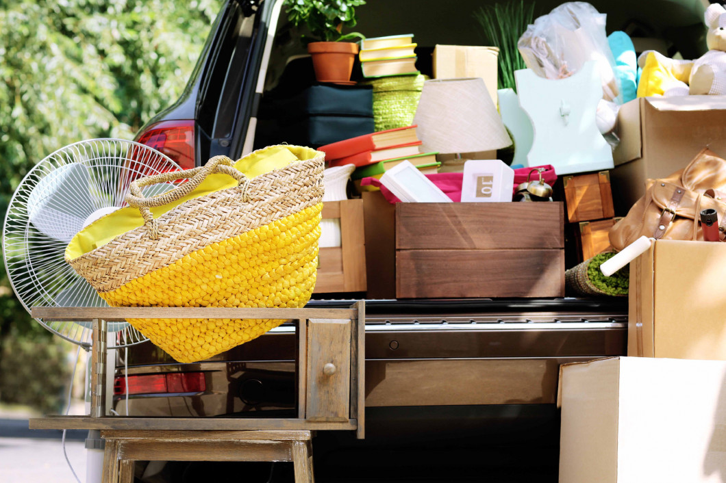 Moving boxes and suitcases in trunk of car, outdoors