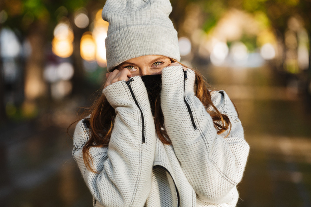 Cheerful young woman dressed in autumn coat