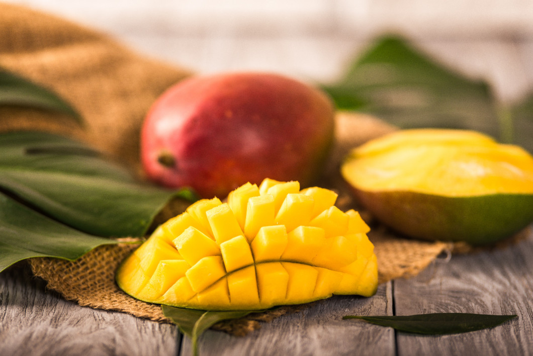 Mango. Tropical Fruits. On a wooden background. Blurred background selective focus.