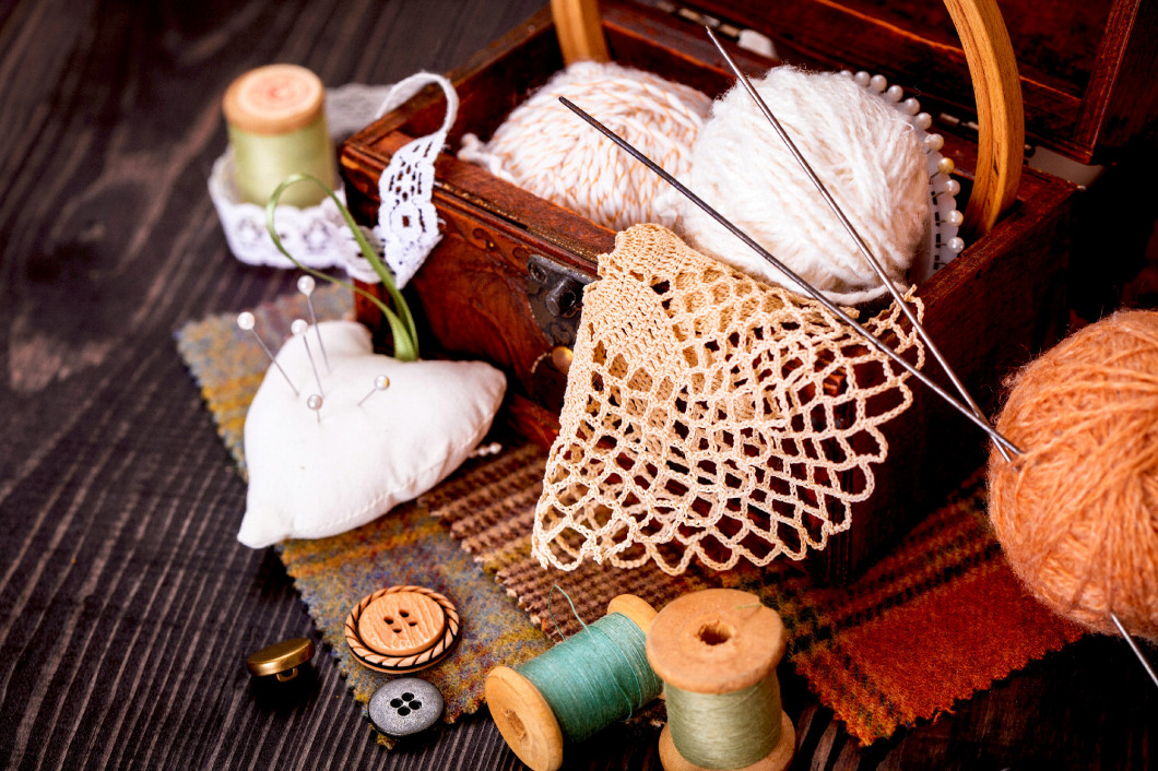 Spool of thread, thimble and a box with needlework