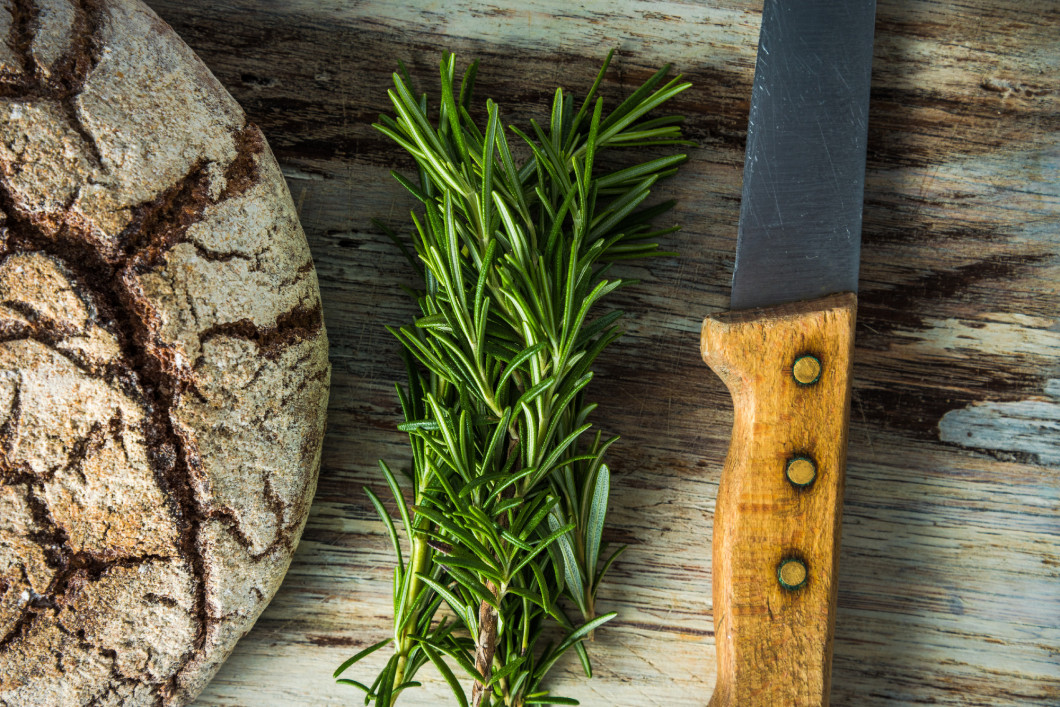 Artisan bread loaf, rosemary and knife