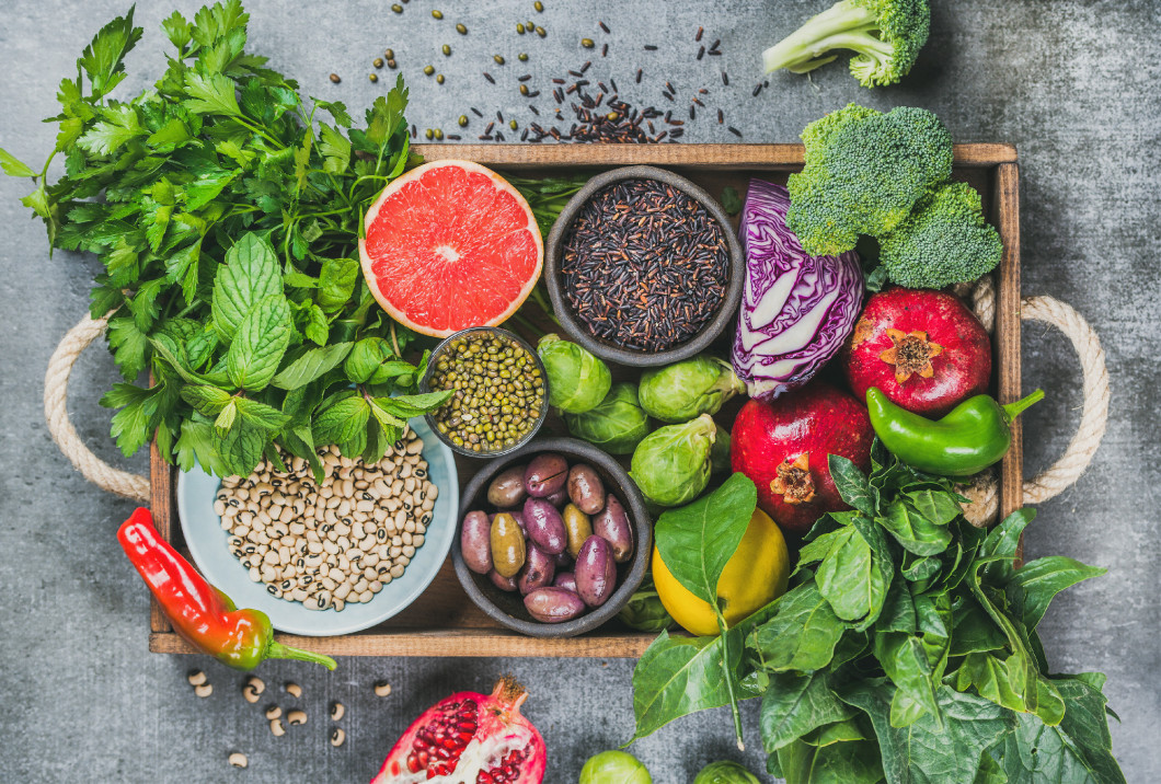 Healthy food in rustic wooden tray over grey background