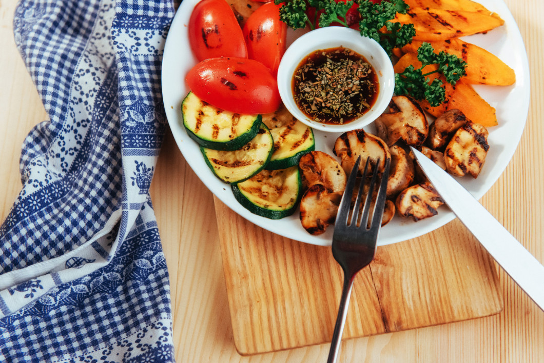 grilled vegetables with sauce on a wooden background